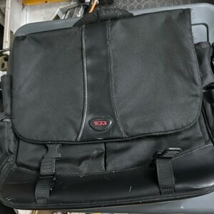 Used Tumi fabric computer bag. The handle has been worn. all the zippers work.